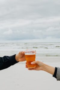 hands holding glass of beer Photo by Karolina Grabowska on Pexels.com